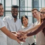 people smiling holding hands in the center