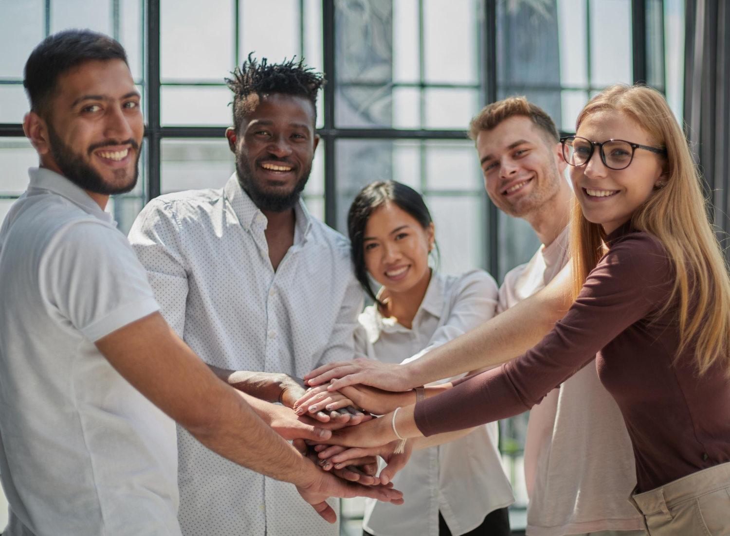 people smiling holding hands in the center